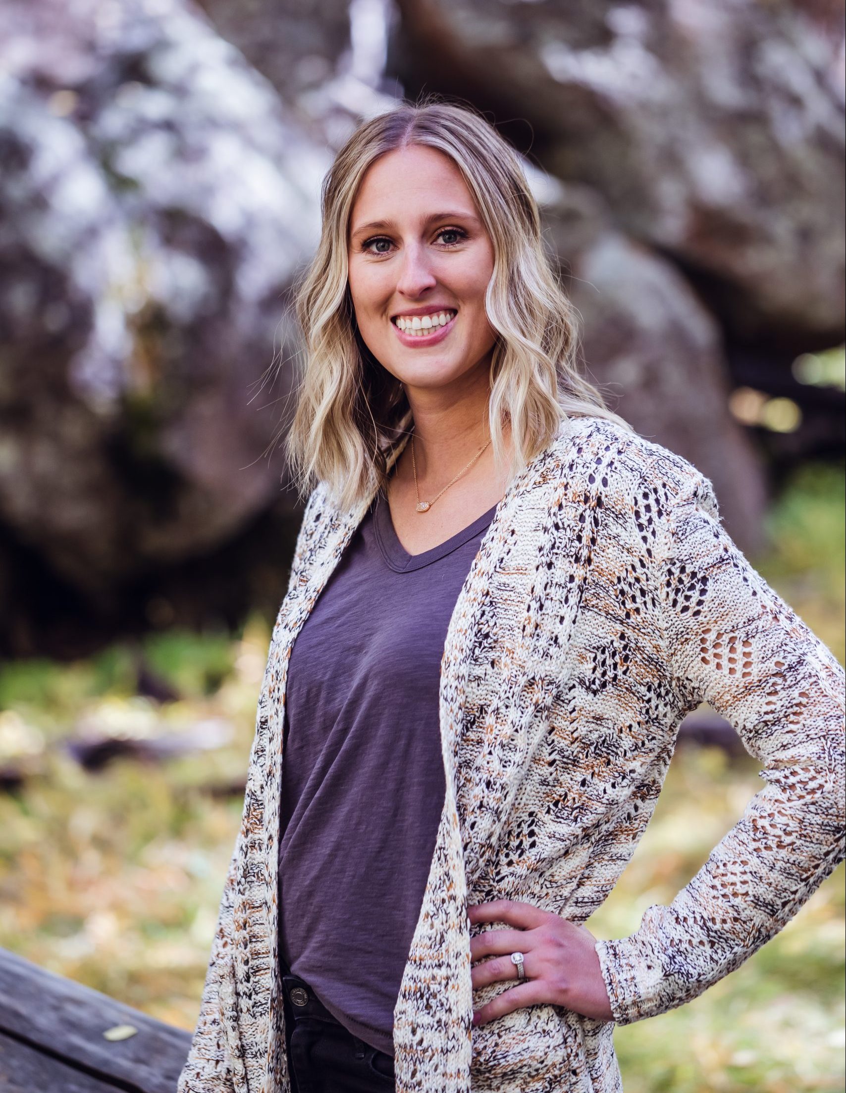 Headshot 1 Dr. Taylor Hunt; pediatric, cosmetic, and family dentist standing in grass near her Snowflake, AZ dental office